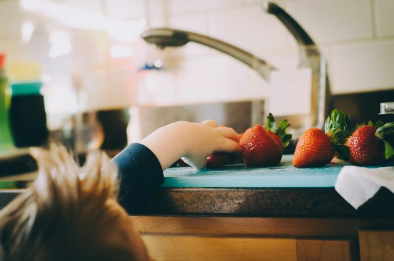 Childs hand with strawberries